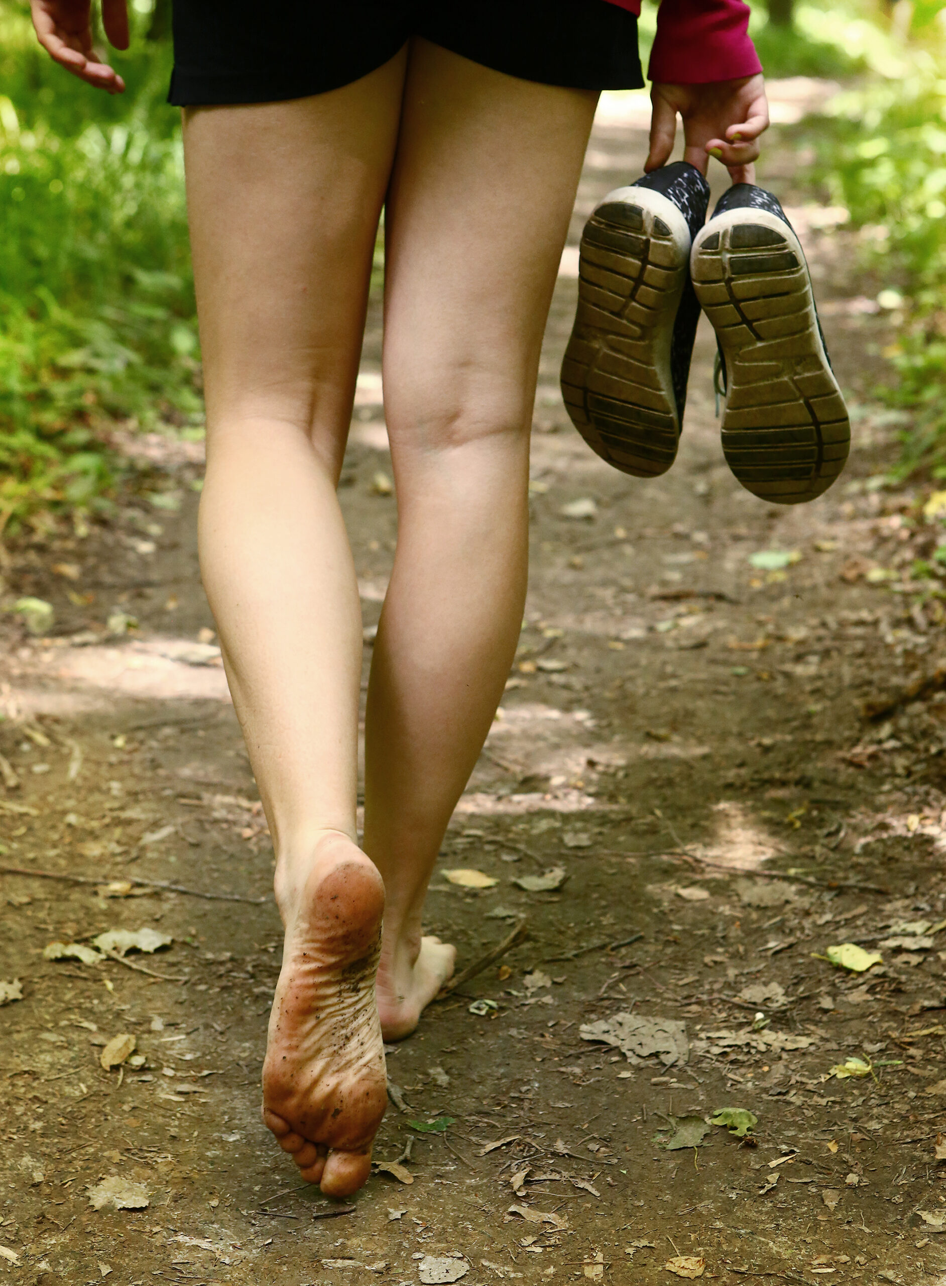 bare feet walking along forest way close up photo